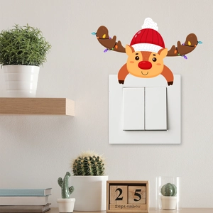 Cute cartoon Christmas reindeer sticker with Santa hat and lights on an indoor light switch