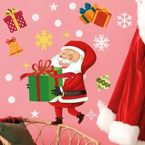 Detailed view of Santa Claus wall decals with snowflakes and gift boxes on pink wall