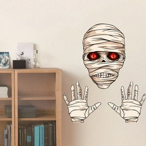 Detailed view of spooky Halloween mummy wall stickers with glowing red eyes on a beige wall