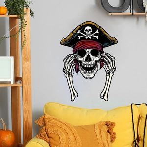 Detail of pirate skull wall sticker on grey background with Halloween room decorations