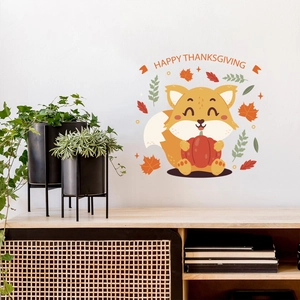 Detail of cute fox holding pumpkin wall sticker with Happy Thanksgiving text on white wall