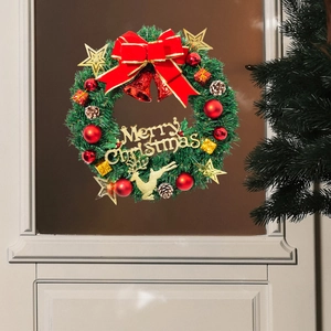 Detailed Christmas wreath decoration with pine needles, red bow and gold Merry Christmas sign