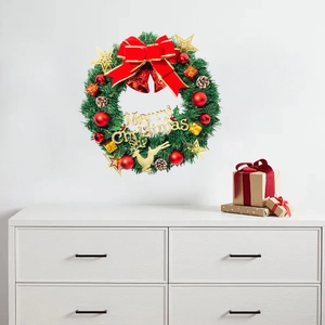 Christmas wreath with pine needles, red bow, and golden Merry Christmas sign for wall decor