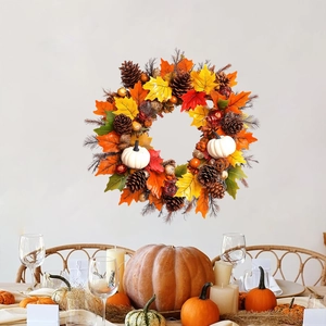Autumn wreath with maple leaves, pine cones and white pumpkins for festive decor