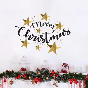 Detail of Merry Christmas wall decal with golden stars above a festive fireplace mantle