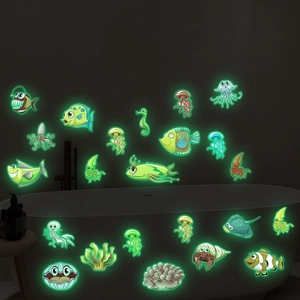 Luminous marine life wall stickers glowing green in a bathroom setting with sea creatures