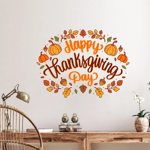 Detail of Happy Thanksgiving wall sticker with pumpkins and maple leaves on a white wall