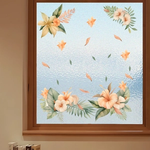 Detail view of hibiscus and palm leaf static window stickers on frosted glass surface