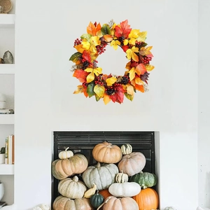 Autumn maple leaf wreath with red and black berries for festive home wall decoration