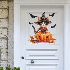 Detail of Halloween magic cat and pumpkin wall sticker on a white wooden door decor