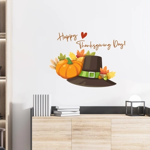Bunte Erntedank-Wandaufkleber mit Kürbis und Herbstlaub auf einer weißen Innenwand
