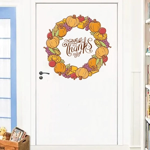 Detail of Give Thanks Thanksgiving door sticker with autumn fruits and pumpkin on a white door