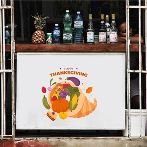 Detail showing Happy Thanksgiving decorative sign with cornucopia on a rustic counter