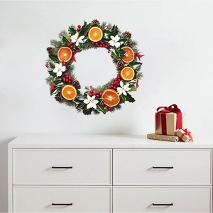 Christmas wall decal with oranges, berries, and pine needles in a Nordic room setting