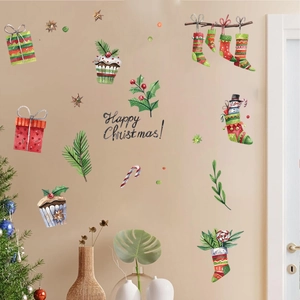 Watercolor Christmas wall decals featuring socks and gift boxes on a beige wall