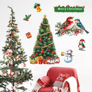 Detail view of festive Christmas tree and snowman wall stickers in a cozy living room scene