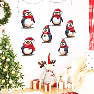 Detail of six festive penguin wall stickers with red Santa hats for Christmas home decor