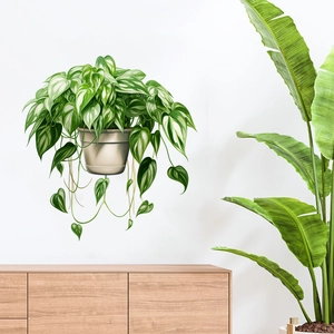Detailed view of 3D green plant wall sticker with white variegated leaves on a white wall