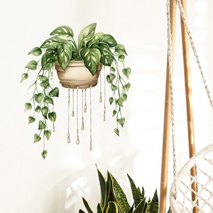 Detail of creative watercolor green plant wall sticker with golden teardrop accents on white wall