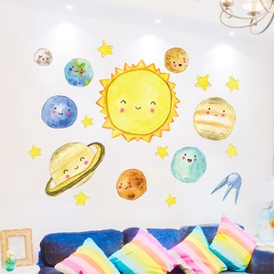 Space themed wall decals with cute cartoon planets and stars in a cozy nursery room