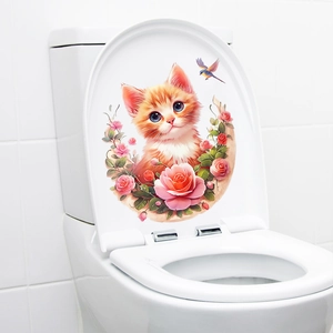 Close-up of cute orange cat and pink rose wreath sticker on a white toilet lid