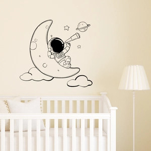 Astronaut on crescent moon wall sticker with stars and planets for nursery decor