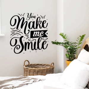 Detail of You Make me Smile wall decal with artistic black font in a cozy bedroom