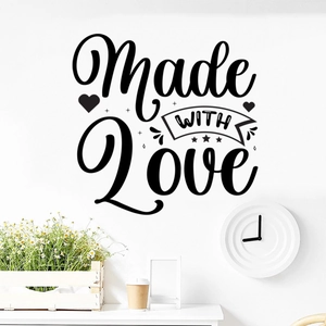 Detail of Made WITH Love black wall decal with heart accents on a white wall decor