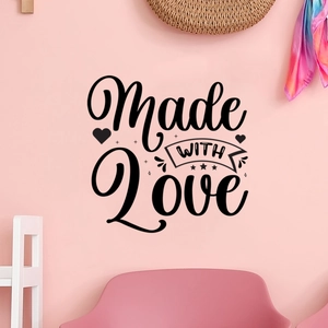 Detail showing 'Made WITH LOVE' black wall decal with heart and floral motifs on pink wall