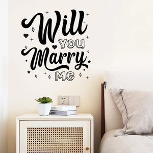 Close-up of 'Will YOU Marry Me' wall decal with heart accents on a modern white wall