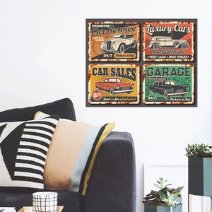 Close-up of four vintage car metal wall art signs displayed over a living room sofa