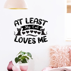 Detail showing 'AT LEAST My Cat LOVES ME' black vinyl wall decal with cat silhouettes