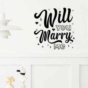 Macro detail of 'Will YOU Marry Me' black vinyl wall decal with romantic heart elements