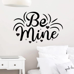 Detail of Be Mine black wall sticker with heart and star motifs on minimalist white wall