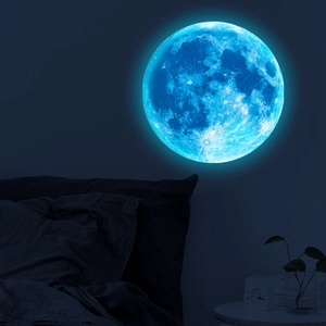 Detailed realistic blue luminous moon wall sticker with crater texture in dark bedroom