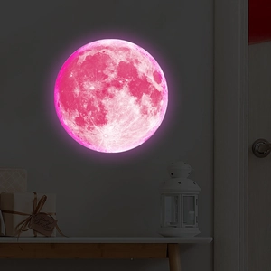 Glow-in-the-dark moon wall sticker with pink lunar surface texture for bedroom decoration
