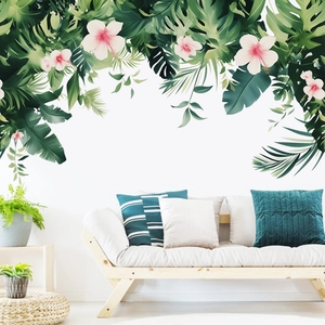 Detail view of tropical wall decals with hibiscus flowers and monstera leaves in a living room