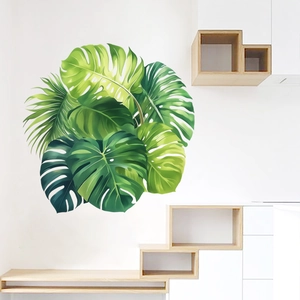 Realistic tropical monstera leaf wall decals on a minimalist white wall in home setting