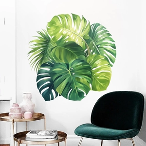 Detailed wall scene showing monstera and palm leaf stickers on a clean white background