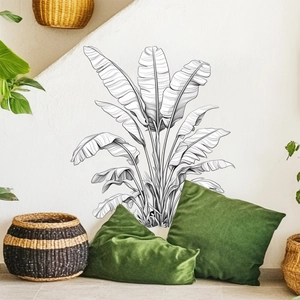 Line art banana leaf wall sticker displayed above a green pillow and woven basket