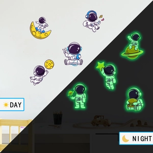 Luminous astronaut wall stickers showing day and night glow effect in children's bedroom