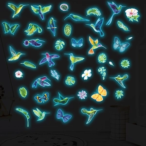 Luminous wall stickers set featuring glowing hummingbirds, butterflies and tropical leaves