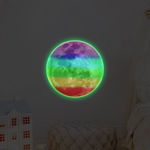 Detailed view of luminous full moon wall sticker with rainbow stripes in a dark nursery