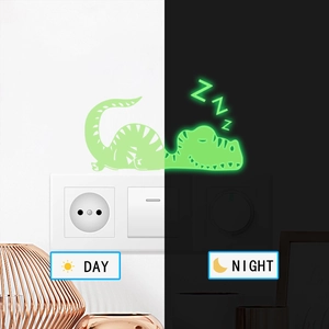 Glow-in-the-dark sleeping dinosaur switch sticker showing day and night luminous contrast effect