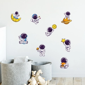 Cartoon astronaut wall stickers set featuring stars and planets for nursery room decoration
