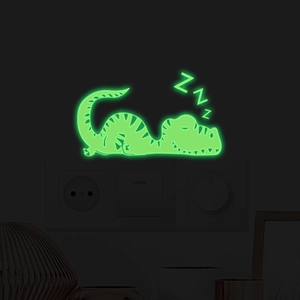 Glow in the dark sleeping dinosaur wall sticker showing luminous green effect at night