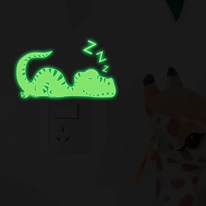 Glow in the dark sleeping dinosaur wall sticker emitting green light near a light switch
