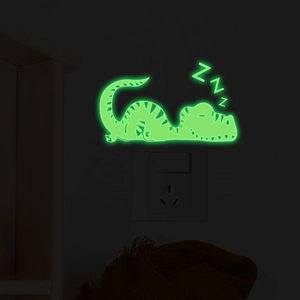 Luminous sleeping dinosaur wall sticker for light switches with glowing green neon effect