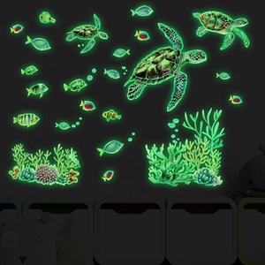 Glow-in-the-dark sea turtle and tropical fish wall stickers shown in dark room