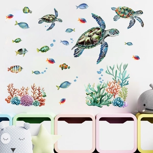 Detail of glow-in-the-dark ocean wall stickers with sea turtles and coral on a white wall